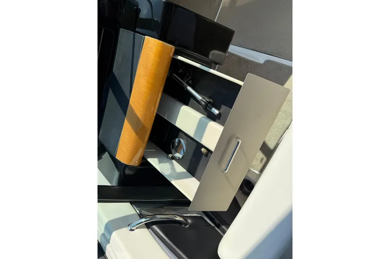 Slide: The Image of 2009 Four Winns SL222 boat interior with open storage compartment and handle. - 11