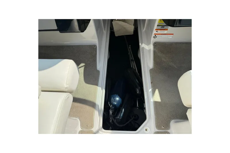 Slide: The Image of 2009 Four Winns SL222 boat interior storage compartment with carpeted flooring. - 15