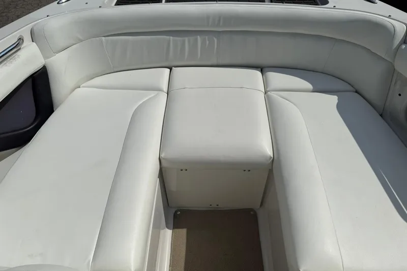 Slide: The Image of 2009 Four Winns SL222 boat interior with white cushioned seating. - 16
