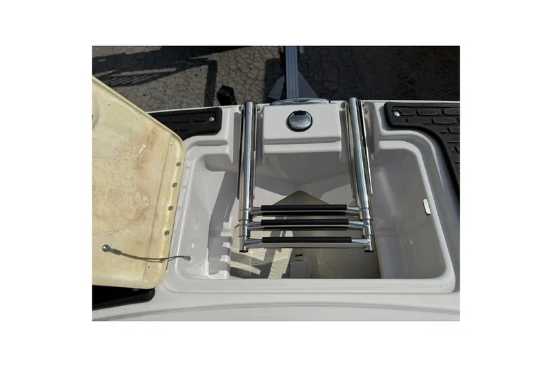 Slide: The Image of 2009 Four Winns SL222 boat storage compartment with foldable ladder. - 18