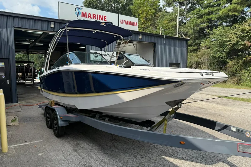 Slide: The Image of 2009 Four Winns SL222 boat on trailer outside marine service center. - 2