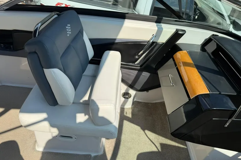 Slide: The Image of 2009 Four Winns SL222 boat interior with cushioned seating and storage compartment. - 9