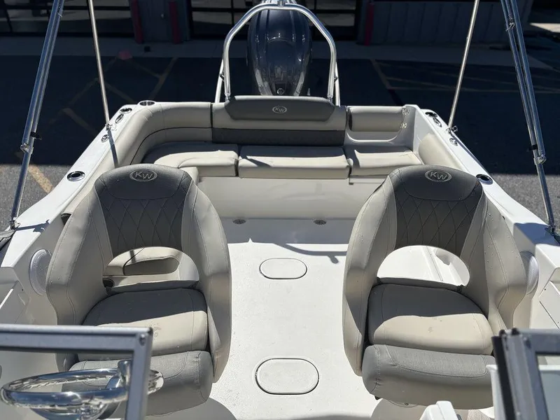 Slide: The Image of 2025 Key West 203 DFS boat interior with cushioned seating and steering console. - 12