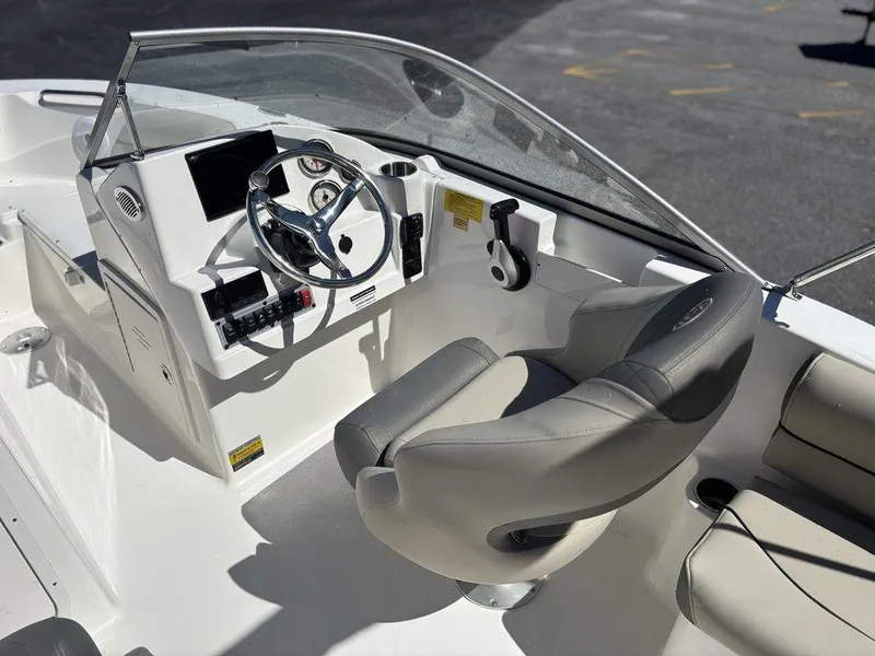 Slide: The Image of 2025 Key West 203 DFS boat interior with steering wheel and seating. - 15