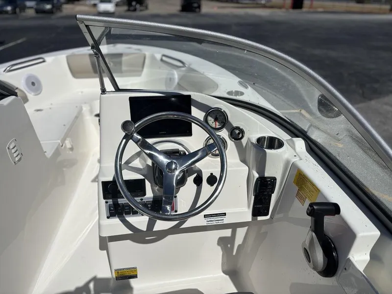 Slide: The Image of 2025 Key West 203 DFS boat dashboard with steering wheel and gauges. - 16