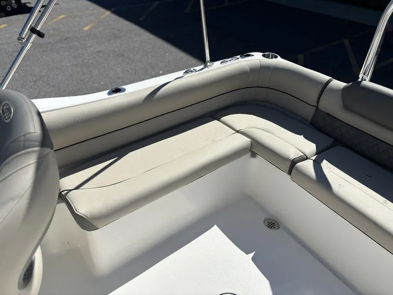 Slide: The Image of 2025 Key West 203 DFS boat interior with beige seating and stainless steel railings. - 17