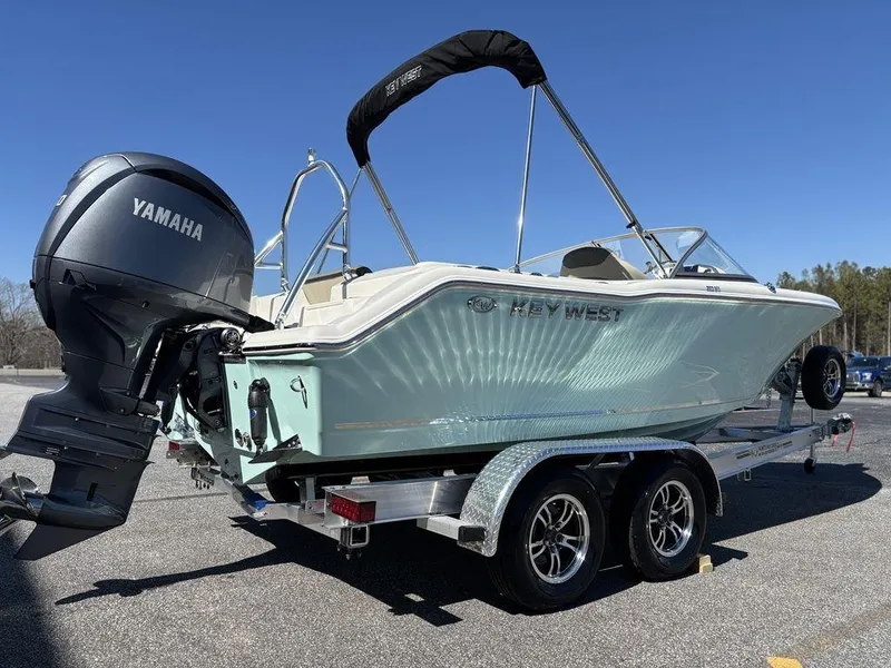 Slide: The Image of 2025 Key West 203 DFS boat on trailer with Yamaha outboard motor, parked outdoors. - 5