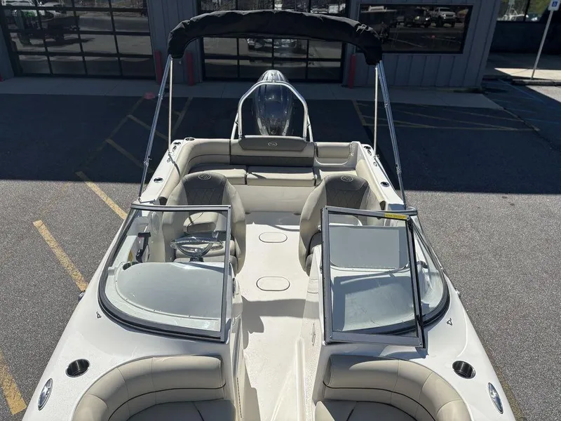 Slide: The Image of 2025 Key West 203 DFS boat with open seating and windshield, parked outdoors. - 8