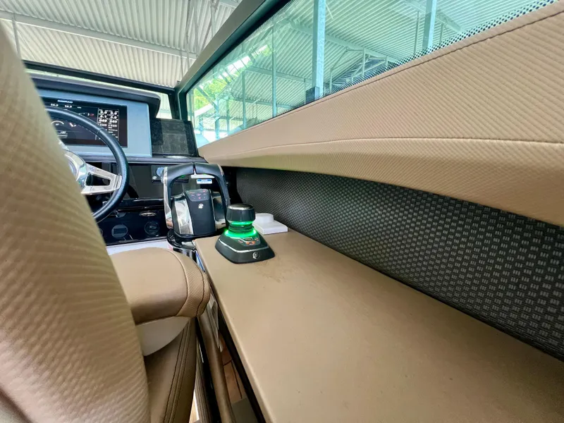 Slide: The Image of 2019 Sea Ray SLX 400 helm with modern controls and luxurious interior design. - 11