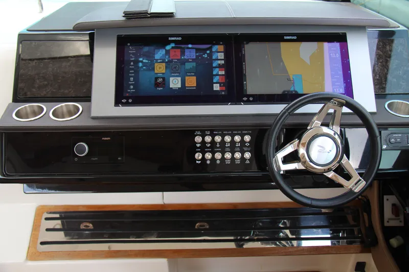 Slide: The Image of 2019 Sea Ray SLX 400 helm with dual Simrad displays and modern steering wheel. - 13