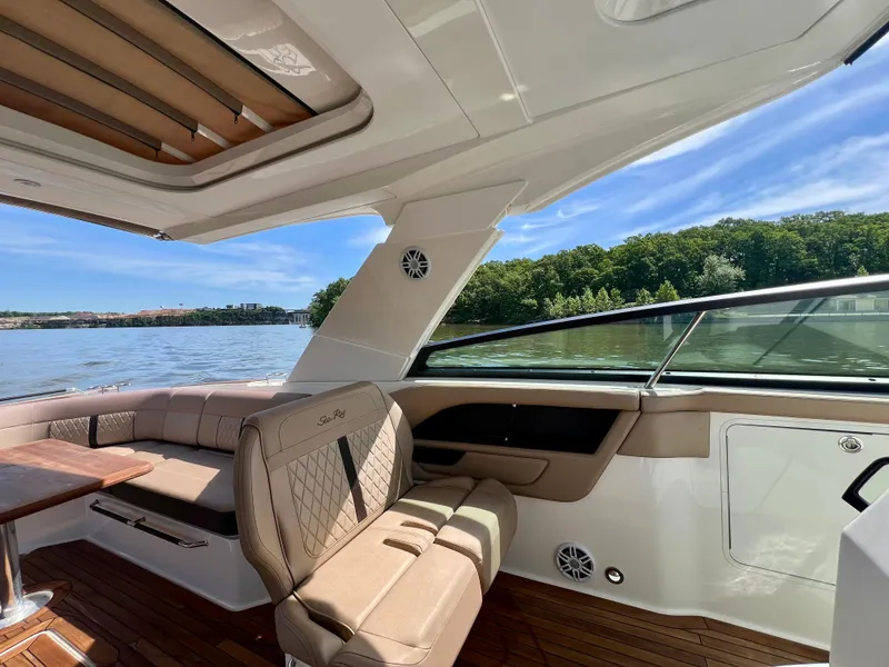 Slide: The Image of Luxurious 2019 Sea Ray SLX 400 boat interior with plush seating and scenic water view. - 14