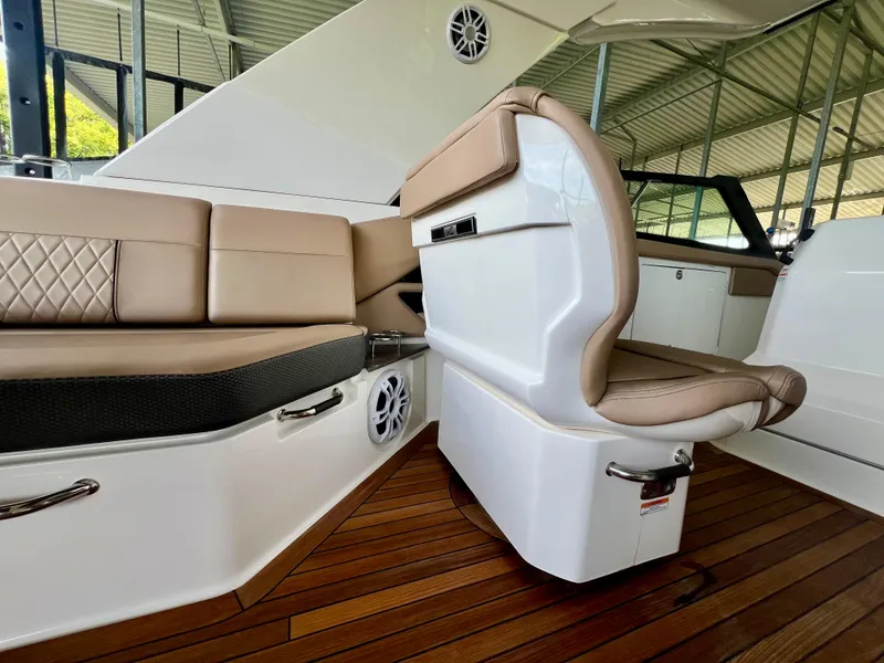 Slide: The Image of Luxurious interior of 2019 Sea Ray SLX 400 with tan leather seating and wood flooring. - 15