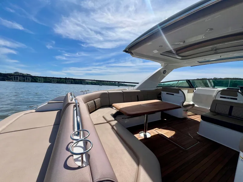 Slide: The Image of 2019 Sea Ray SLX 400 boat with spacious seating and table on a sunny day. - 18