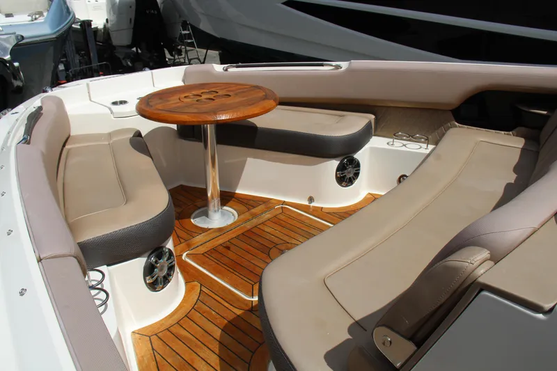 Slide: The Image of 2019 Sea Ray SLX 400 boat interior with teak flooring and cushioned seating. - 25