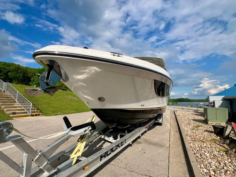 Slide: The Image of 2019 Sea Ray SLX 400 boat on trailer under a blue sky. - 3