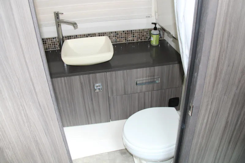 Slide: The Image of 2019 Sea Ray SLX 400 bathroom with modern sink and toilet. - 35