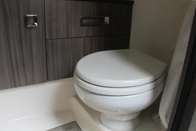 Slide: The Image of Modern bathroom in 2019 Sea Ray SLX 400 boat with sleek cabinetry and toilet. - 37