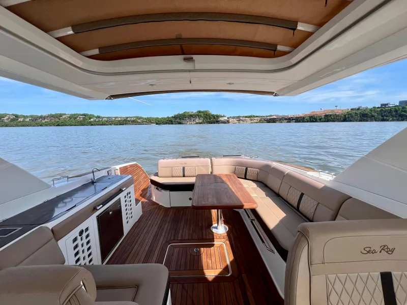 Slide: The Image of 2019 Sea Ray SLX 400 boat interior with luxurious seating and scenic water view. - 7