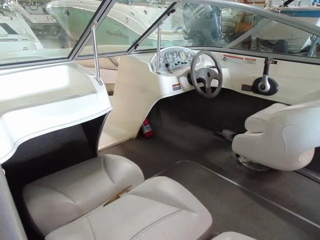 Slide: The Image of Interior of a 2009 Bayliner 175 boat, featuring steering wheel and seating. - 10