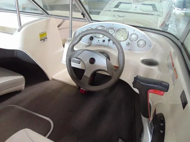 Slide: The Image of 2009 Bayliner 175 boat interior with steering wheel and dashboard controls. - 11