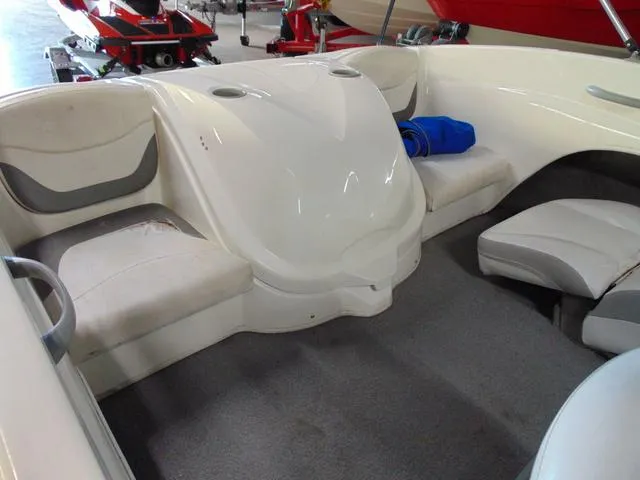 Slide: The Image of 2009 Bayliner 175 boat interior with white seating and carpeted floor. - 5