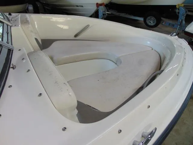 Slide: The Image of 2009 Bayliner 175 boat interior with white cushioned seating. - 6