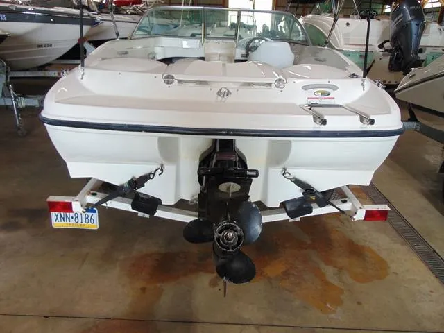 Slide: The Image of 2009 Bayliner 175 boat in storage, rear view showing outboard motor and trailer. - 8