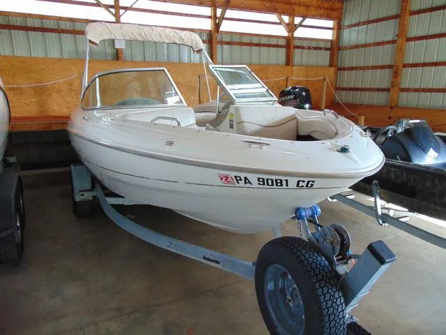 Slide: The Image of 2000 Maxum 1900SR boat on trailer in storage facility. - 1