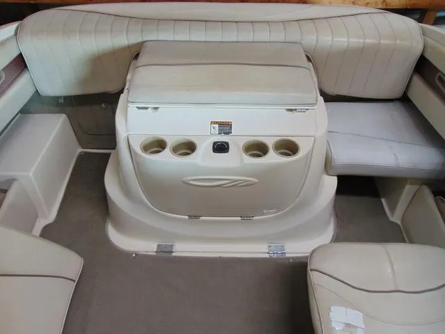 Slide: The Image of Interior of a 2000 Maxum 1900SR boat with beige seating and cup holders. - 10