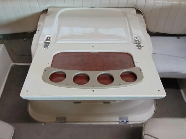 Slide: The Image of Interior of a 2000 Maxum 1900SR boat featuring a foldable table with cup holders. - 11