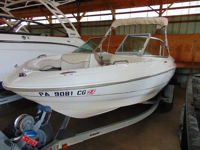 Slide: The Image of 2000 Maxum 1900SR boat on trailer in storage facility. - 2