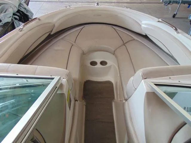 Slide: The Image of Interior of a 2000 Maxum 1900SR boat, featuring beige seating and cup holders. - 5