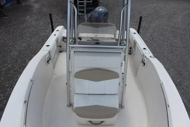 Slide: The Image of 2018 Robalo R180 boat interior with seating and console, viewed from above. - 15