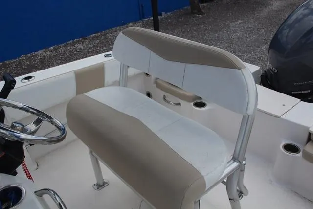 Slide: The Image of 2018 Robalo R180 boat interior with beige and white seating. - 19