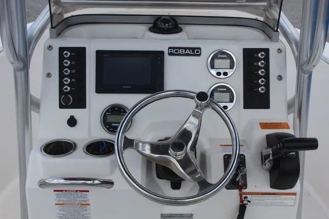 Slide: The Image of 2018 Robalo R180 boat dashboard with steering wheel and control panel. - 20