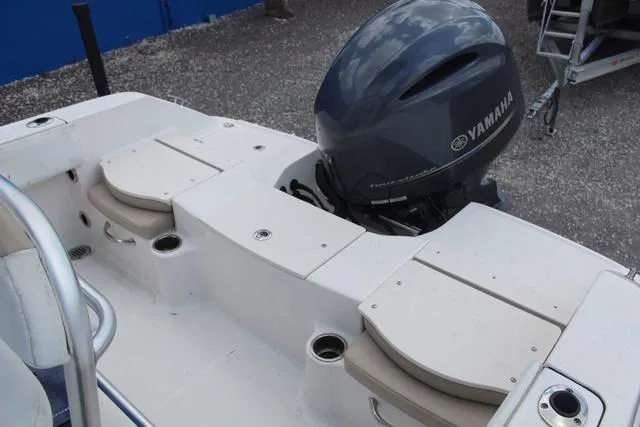 Slide: The Image of 2018 Robalo R180 boat with Yamaha outboard motor, featuring seating and cup holders. - 25