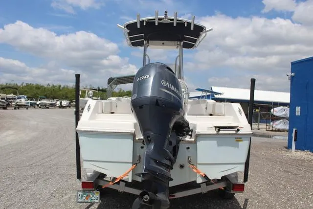 Slide: The Image of 2018 Robalo R180 boat with Yamaha 150 engine, parked outdoors under a cloudy sky. - 5