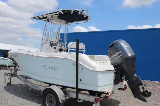 Slide: The Image of 2018 Robalo R180 boat with Yamaha engine on trailer, parked outdoors. - 6