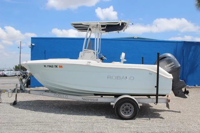 Slide: The Image of 2018 Robalo R180 boat on trailer with Yamaha engine, parked outdoors. - 7