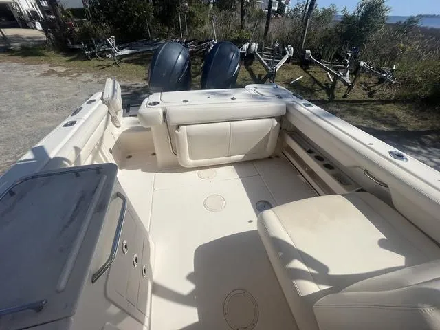 Slide: The Image of 2016 Grady-White Freedom 275 boat interior with dual engines, spacious seating, and storage compartments. - 13