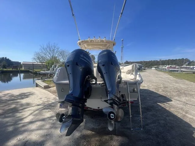 Slide: The Image of 2016 Grady-White Freedom 275 boat with dual Yamaha outboard motors at a marina. - 5