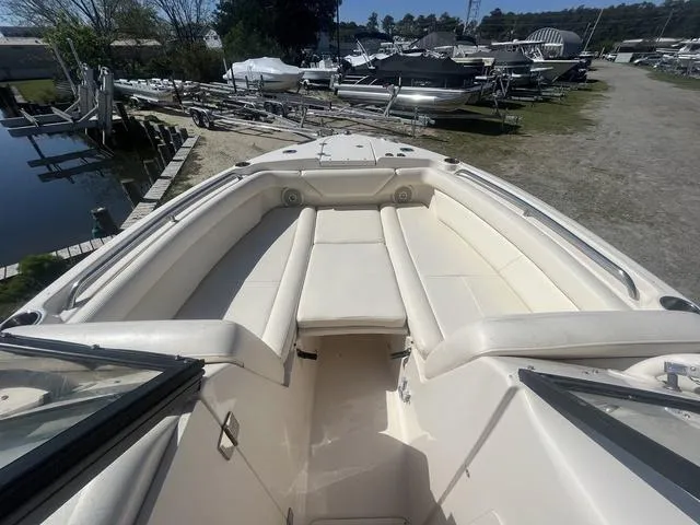 Slide: The Image of 2016 Grady-White Freedom 275 boat with spacious seating, docked near other boats. - 8