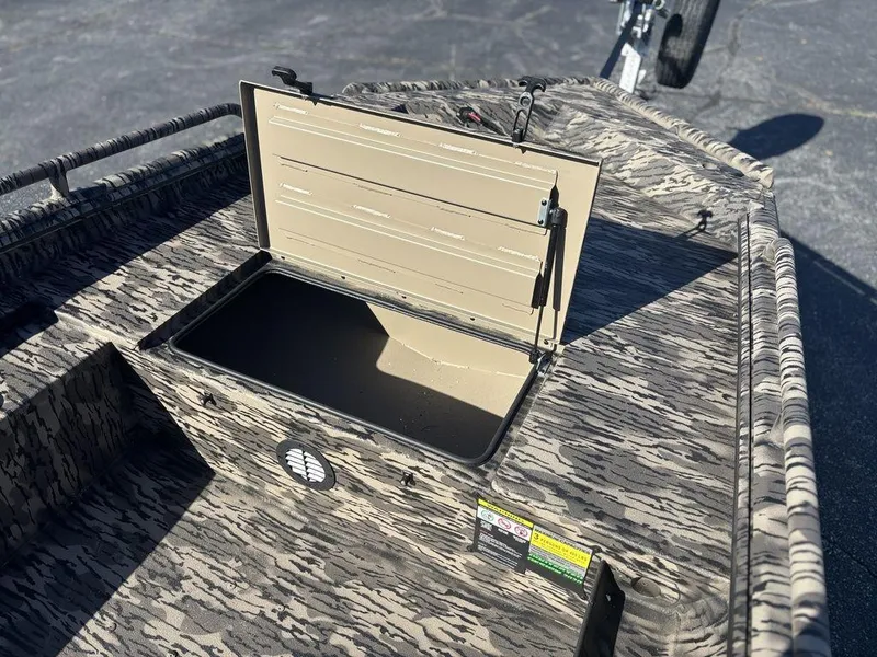 Slide: The Image of Open storage compartment on 2025 Havoc DBST 1656 boat, featuring camouflage design. - 13