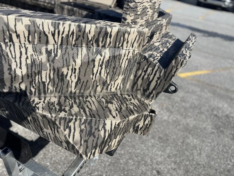 Slide: The Image of Camouflage-patterned Havoc DBST 1656 boat, 2025 model, parked on pavement. - 15