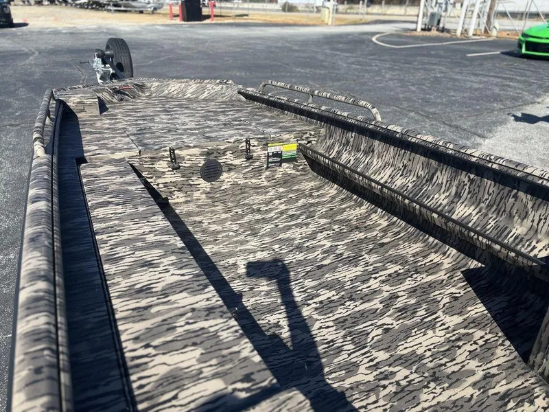 Slide: The Image of 2025 Havoc DBST 1656 boat with camouflage pattern, parked on asphalt. - 6