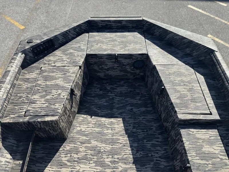 Slide: The Image of 2025 Havoc DBST 1656 boat interior with camo pattern and storage compartments. - 8