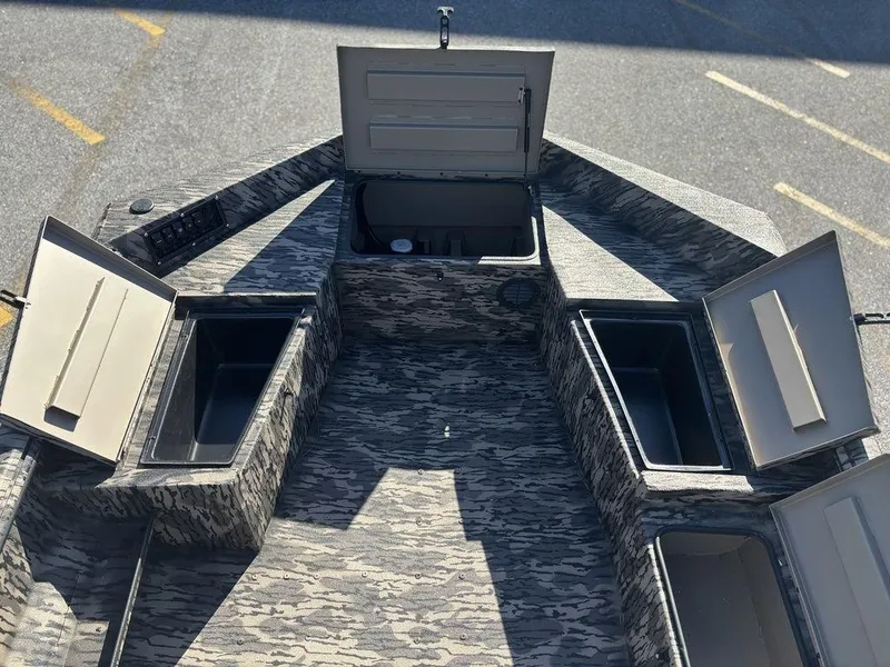 Slide: The Image of 2025 Havoc DBST 1656 boat with open storage compartments, showcasing camo design. - 9