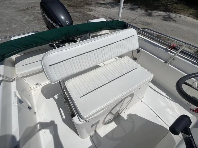 Slide: The Image of 1999 Boston Whaler 160 Dauntless boat interior with white seating and steering wheel. - 10