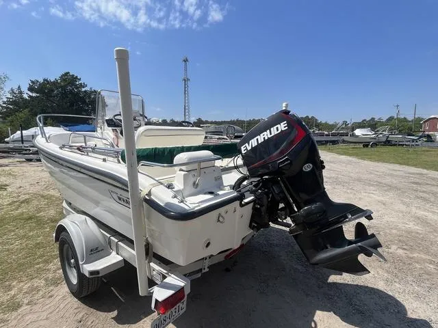Slide: The Image of 1999 Boston Whaler 160 Dauntless boat with Evinrude motor on trailer, parked outdoors. - 4