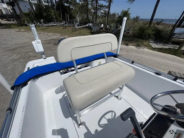 Slide: The Image of 2017 Sportsman 17' Island Reef boat interior with beige seating and steering wheel. - 9